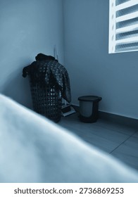 A dustbin and wastebin in a corner of a bedroom 