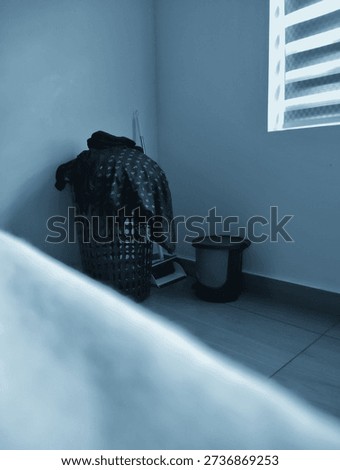 A dustbin and wastebin in a corner of a bedroom 