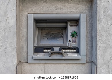 Dusty Broken ATM Machine In The Bank Wall. Abandoned Banking Equipment Outdoors