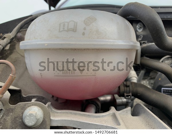 Dusty coolant expansion tank with liquid\
level below minimum indication coolant\
loss