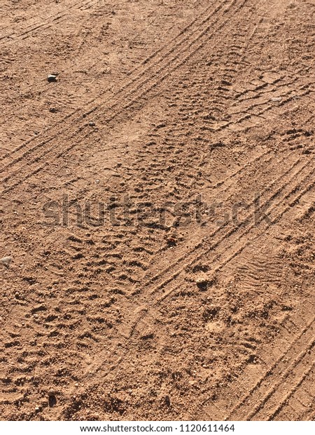 Dusty Dirt\
Road with Tire Tracks Debris Rocks\
Sand