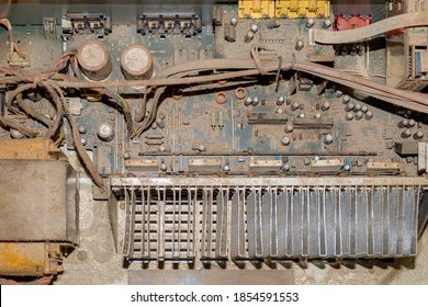 A dusty, dirty circuit board. Various components and wires covered with dust. Function and brand not identifiable.