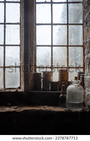Dusty old bottles stored on a window ledge