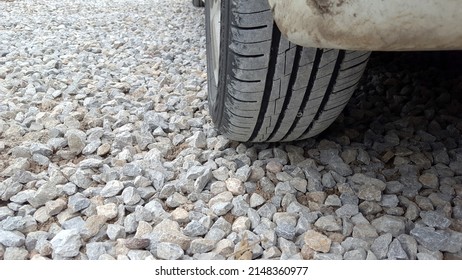 Dusty Tires Lay On The Gravel Floor.