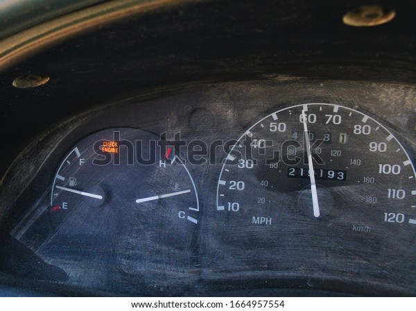 Dusty truck dashboard with speedometer, gas gauge,\
and heat gauge