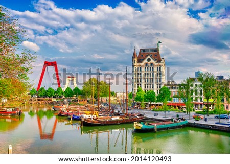 Dutch Destination. Cityscape of Rotterdam with Railway Transportation Bridge in Background and Small Sailboats in Foreground In Port and Harbour. Picture Made In the Evening. Horizontal Image