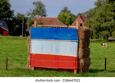 The Dutch Farmers Are Protesting (Boerenprotest) At Government Aims To Reduce Nitrogen (stikstof) Compound Emissions, Netherlands Flag On The Green Filed In Countryside Farm As Protest, Netherlands.