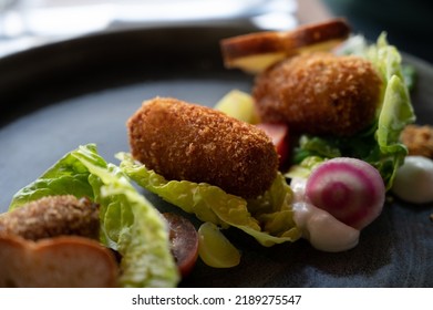 Dutch Fast Food, Deep Fried Croquettes Filled With Ground Beef Meat And Served With Green Salad, Close Up