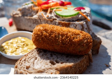 Dutch fast food, deep fried croquettes filled with ground beef meat served on bread, close up - Powered by Shutterstock