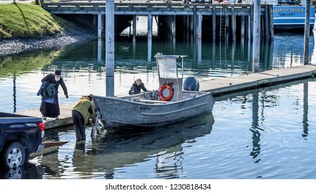DUTCH HARBOR, ALASKA - September 15, 2018: A Russian Orthodox Priest and His Family on a Dock Tying Up Their Boat