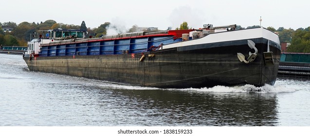 Dutch inland vessel on a German waterway. River cargo ship. Freight transport