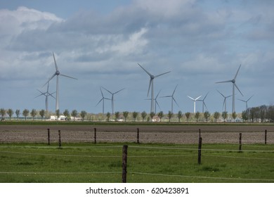 Dutch landscape cows,clouds and windmills Netherlands April 2017 - Shutterstock ID 620423891