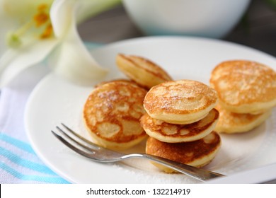 Dutch mini pancakes called poffertjes, sprinkled with powdered sugar