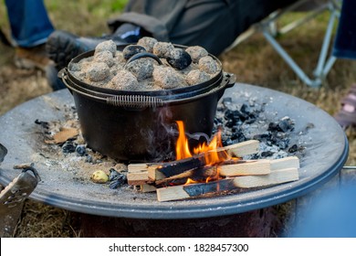 Dutch Oven Campfire Cooking With Coal Briquettes On Top, Camping Life.