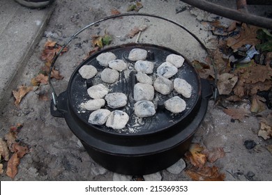 Dutch Oven With Coals On Top In A Fire Pit