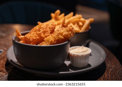 Dutch snacks for beer or wine, french fried potato chips and deep fried tempura shrimps and hot dip sauce and mayonnaise - Powered by Shutterstock