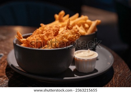 Dutch snacks for beer or wine, french fried potato chips and deep fried tempura shrimps and hot dip sauce and mayonnaise