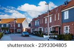 Dutch Suburban area with modern family houses, street with modern family homes in the Netherlands