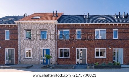 Dutch Suburban area with modern family houses, newly build modern family homes in the Netherlands, dutch family houses, and apartment houses. In the Netherlands, newly build streets with modern house