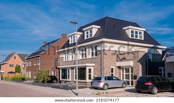 Dutch Suburban area with modern family houses,\
newly build modern family homes in the Netherlands, dutch family\
houses, and apartment houses. In the Netherlands, newly build\
streets with modern house