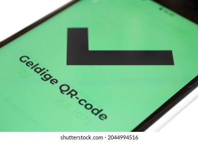 Dutch text "Valid QR code" on the green screen of a smartphone which means that the visitor has been vaccinated or tested negative. CoronaCheck Scanner. Narrow depth of field