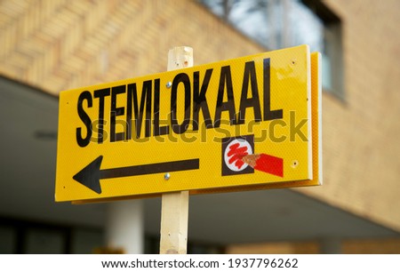 Dutch-language sign that points the way to the polling station for gemeenteraadsverkiezingen nederland