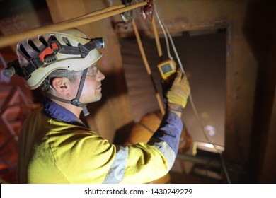 Duty Of Care Certified Site Safety Officer Inspector Conducting Inspecting Gas Testing Atmosphere Detector Hanging On Entry And Exit Confined Space Manhole Door While Friend Are Working Inside 