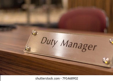 Duty Manager Sign On Table In Hotel Reception Lobby