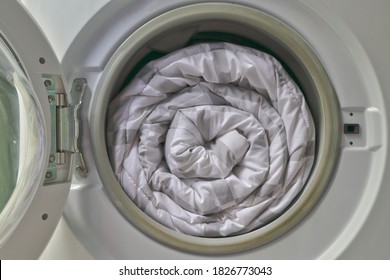 Duvet Rolls Inside Washing Machine , Cleaning White Blanket. 