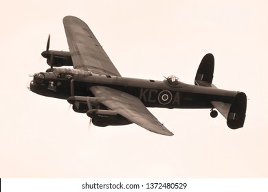 DUXFORD, CAMBRIDGESHIRE, UK - SEPTEMBER 14, 2014: A black and white period image of Battle of Britain Memorial Flight's Avro Lancaster BII PA474 'City of Lincoln' bomber as it displays over Duxford.