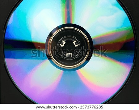 A DVD disc in a box, close-up. A digital storage medium. Multicolored spectrum of the disc surface