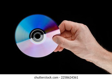 DVD disc in hands on black - Shutterstock ID 2258624361