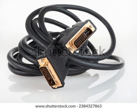 Dvi digital video cable for connecting an external TV screen monitor to a computer laptop for watching video video signal transmission isolated on a white background close-up