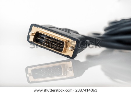 DVI digital video cable for connecting an external TV screen monitor to a computer laptop for watching video video signal transmission isolated on a white background close-up
