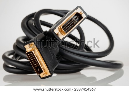 DVI digital video cable for connecting an external TV screen monitor to a computer laptop for watching video video signal transmission isolated on a white background close-up