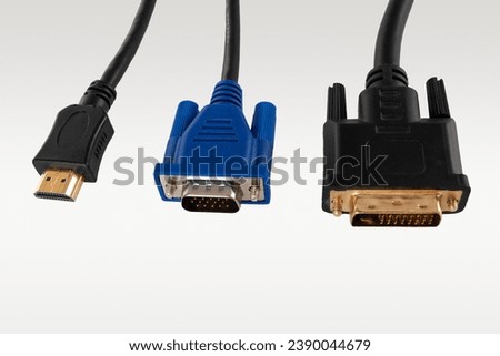 DVI HDMI digital and VGA analog video cable for connecting an external TV screen monitor to a computer laptop for watching video video signal transmission isolated on a white background close-up