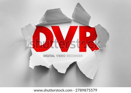 DVR text revealed through torn paper surface, illustrating a digital media concept related to video storage, recording activity and playback usage