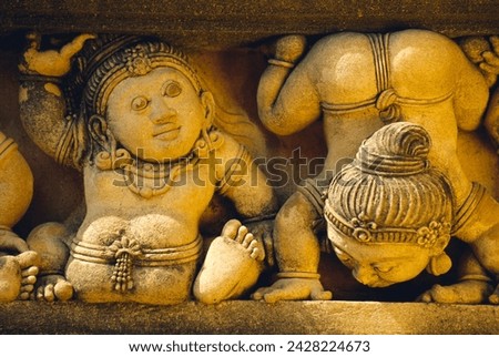 Dwarf carvings line temple wall, kelaniya temple, near colombo, sri lanka, asia