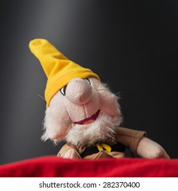 Dwarf Portrait With Yellow Hat On A Black Background