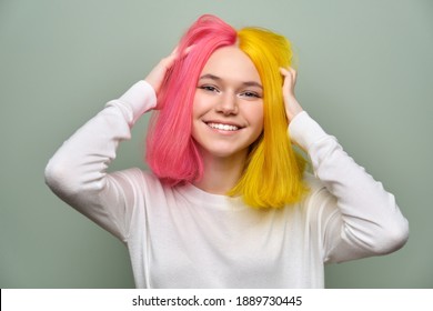 Dyed Long Hair Close-up, Girl Fashion Beauty Model Showing Coloring On Her Hair, Green Studio Background. Professional Coloring, Beauty, Fashion, Trends