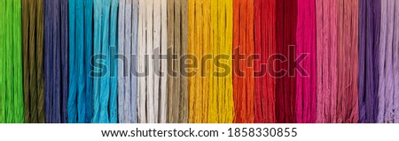 Dyed thread or cord or packthread color hang on the wall for background usage.