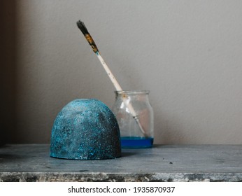 
dyeing process in cement object with sulfate technique. Grey background. Verdigris painting
