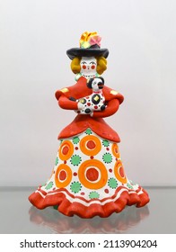 Dymkovskaya Toy. Russian National Clay Doll, As Woman In Retro Costume In Dymkovo Painting Style With Circles. Toy With Hat And Dog. Folk Art. Souvenir From Russia. Vertical.