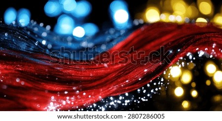 Dynamic abstract image featuring flowing red and blue light streaks with a soft bokeh background of blue and yellow lights.