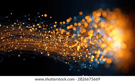 A dynamic abstract image featuring a swirling vortex of golden and orange bokeh lights against a deep black background, suggesting energy and movement.