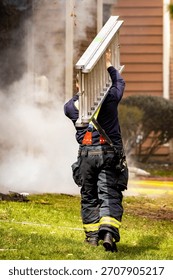 A dynamic, action-oriented view of a firefighter in full protective gear carrying a heavy ladder toward a building engulfed in flames and smoke during a fire emergency