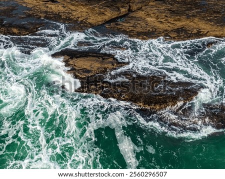 Similar – Image, Stock Photo Waves crashing on the rugged Praia Jalé shoreline