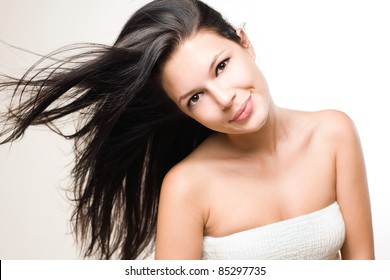Dynamic beauty shot of gorgeous brunette with flowing hair.
