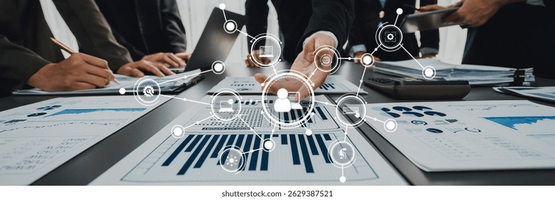 A dynamic business meeting scene highlighting teamwork and data analysis. Participants engage using modern technology, showcasing charts and graphs for strategic planning and collaboration. Amity