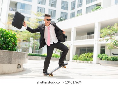 Dynamic businessman with positive attitude towards life balancing on a skateboard - Powered by Shutterstock